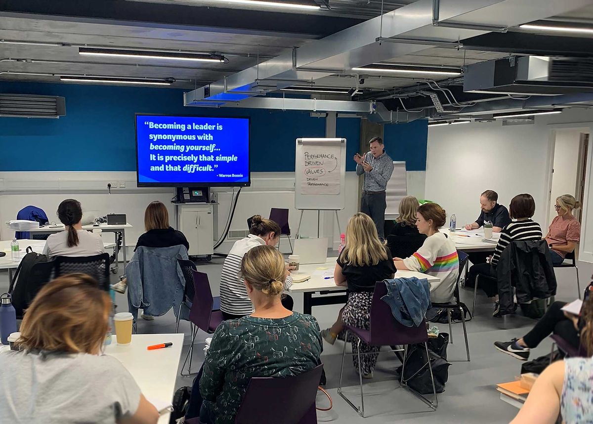 Justin McKeown leading an interactive leadership development session with a group of participants